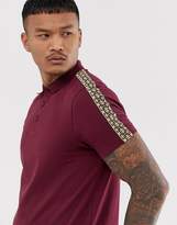 Thumbnail for your product : ASOS Design DESIGN polo shirt with geo taping in burgundy-Red