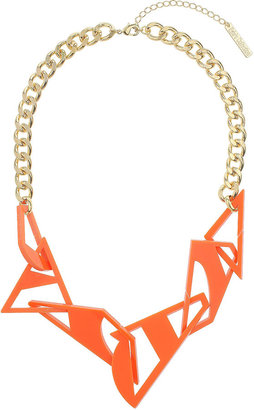 Topshop Gold look necklace with assorted shaped orange cut out plastic pieces, length 10 inches with 2 inch extension chain. part of the central saint martins collection for freedom at 100% plastic.