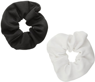 Topshop Freedom at 100% fabric. Set of two fabric hair scrunchies, one black and one white, unstretched width 11cm.