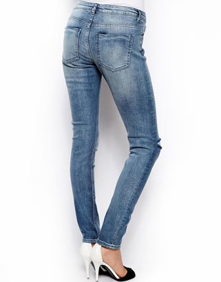 ASOS Whitby Low Rise Skinny Jeans in Randolph Mid Wash Blue With Ripped Knee