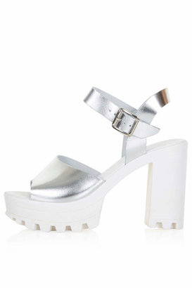 Topshop Silver chunky platforms with cleated sole and ankle strap. heel height approximately 4". 100% leather.
